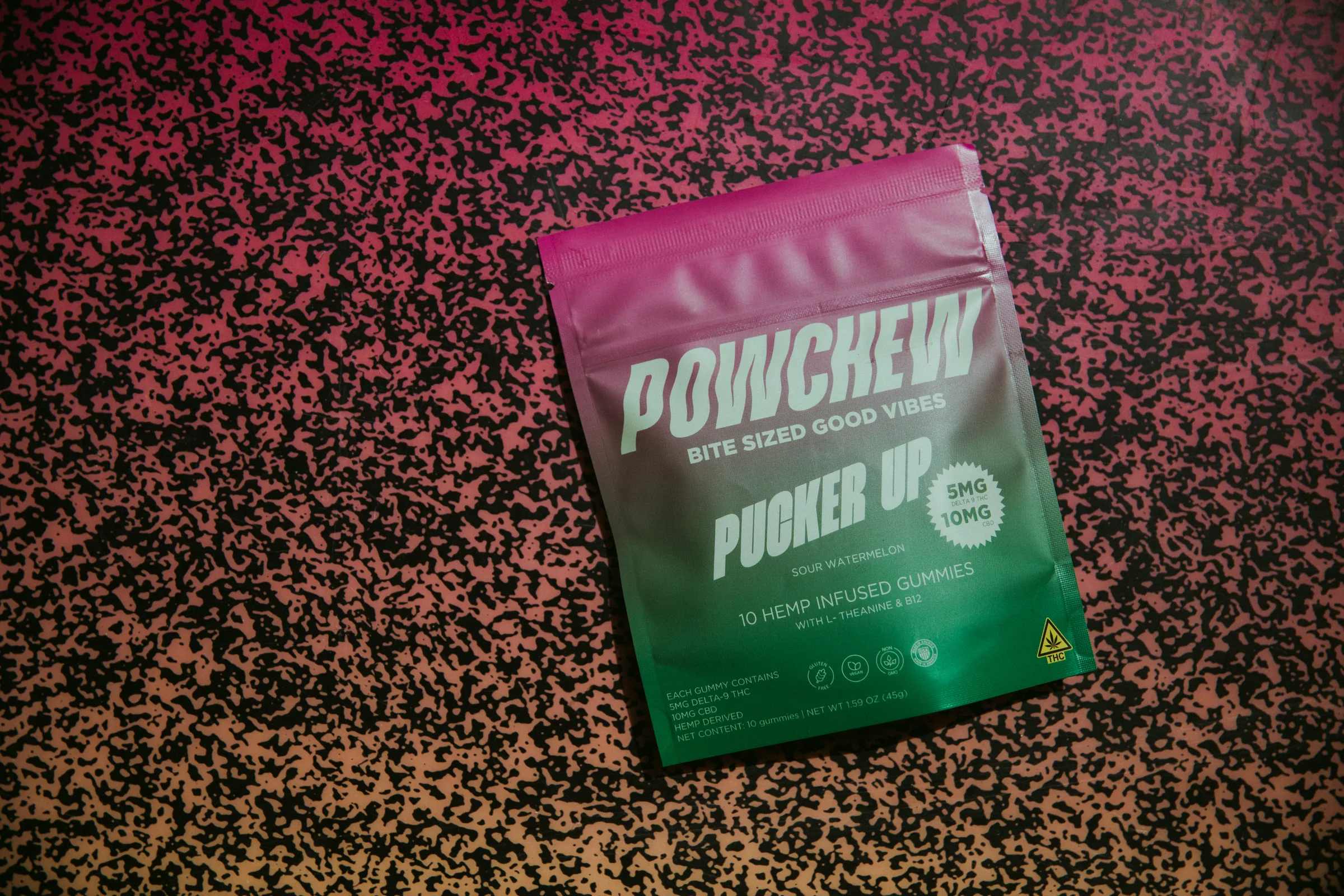 Pucker Up pouch on a pink and black speckled floor